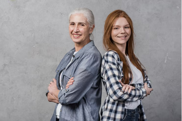 Mom and daughter backing each other in a friendly power pose and smiling.
