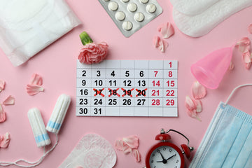 Period supplies like tampons, menstrual pads, calendar, face mask, menstrual cup, pills in blister pack, flowers, clock on pick background. 